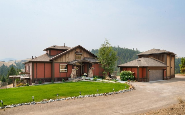 162 Jackson Creek Rd, Montana City, MT 59634 - view of front of property featuring dirt driveway, a garage, a front lawn, and a mountain view