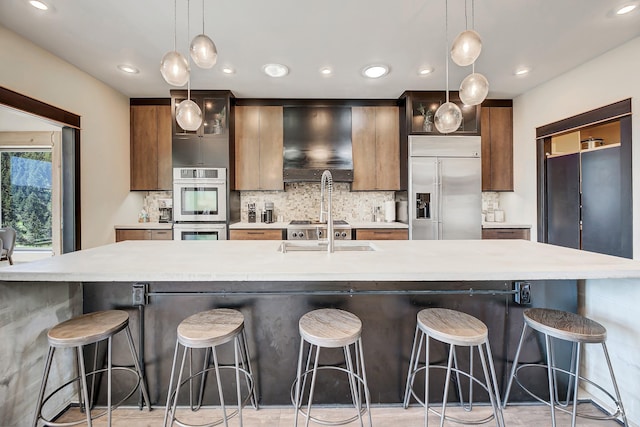 162 Jackson Creek Rd, Montana City, MT 59634 - kitchen with built in fridge, light countertops, decorative backsplash, exhaust hood, and recessed lighting