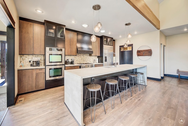162 Jackson Creek Rd, Montana City, MT 59634 - kitchen featuring stainless steel double oven, custom exhaust hood, light countertops, tasteful backsplash, and recessed lighting