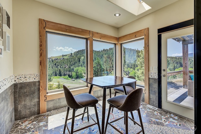162 Jackson Creek Rd, Montana City, MT 59634 - dining space with a skylight, a wooded view, recessed lighting, and a mountain view