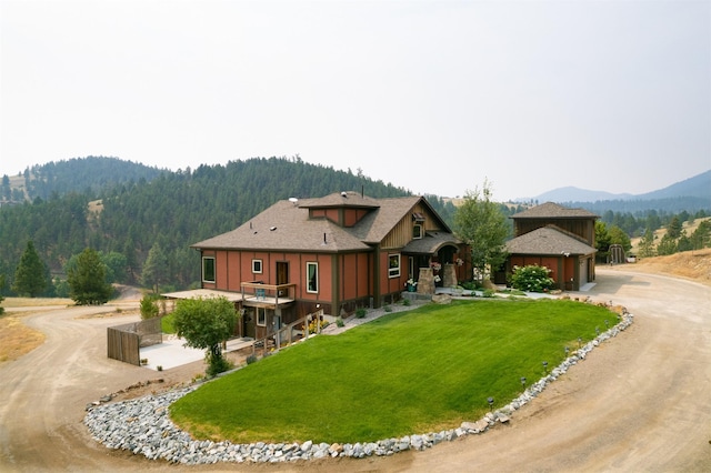 162 Jackson Creek Rd, Montana City, MT 59634 - view of front of home featuring curved driveway, a mountain view, a garage, and a front lawn