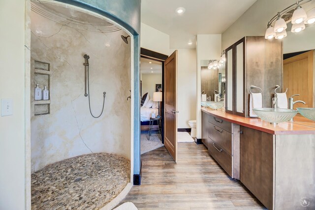 162 Jackson Creek Rd, Montana City, MT 59634 - bathroom featuring toilet, a shower, wood finished floors, double vanity, and ensuite bath