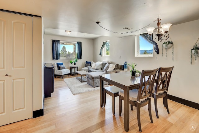 162 Jackson Creek Rd, Montana City, MT 59634 - dining space with a chandelier, light wood finished floors, and baseboards