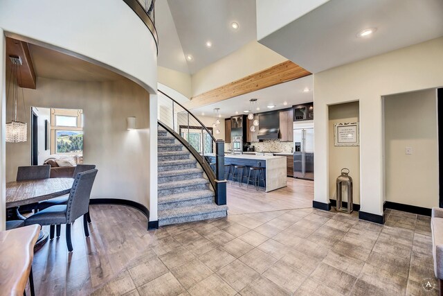 162 Jackson Creek Rd, Montana City, MT 59634 - stairway with healthy amount of natural light, arched walkways, recessed lighting, and baseboards