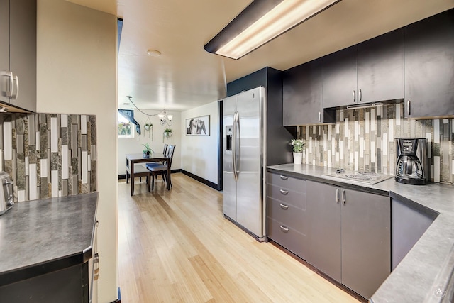 162 Jackson Creek Rd, Montana City, MT 59634 - kitchen featuring stainless steel fridge, tasteful backsplash, a chandelier, light wood-type flooring, and electric stovetop