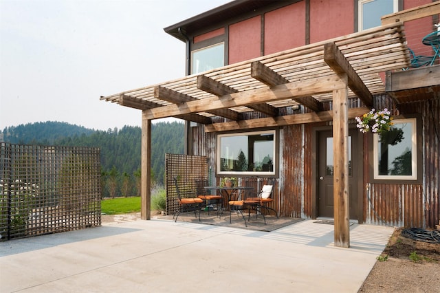 162 Jackson Creek Rd, Montana City, MT 59634 - view of patio / terrace with a pergola and a wooded view