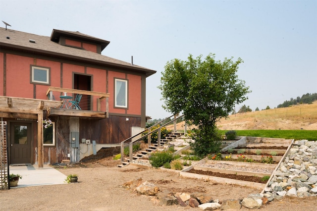 162 Jackson Creek Rd, Montana City, MT 59634 - back of property featuring a garden and stairway