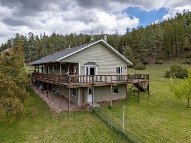 7551 York Rd, Helena, MT 59602 - rear view of house featuring a wooded view, a deck, a lawn, and stairway