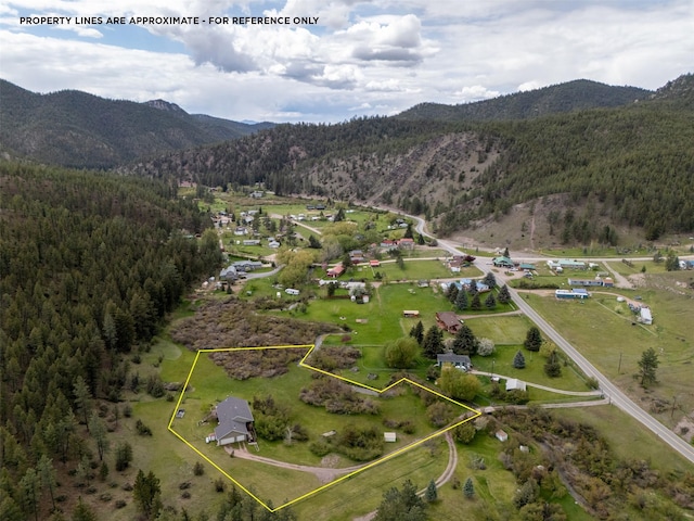 7551 York Rd, Helena, MT 59602 - aerial view of property's location featuring a heavily wooded area, mountains, and property boundaries highlighted