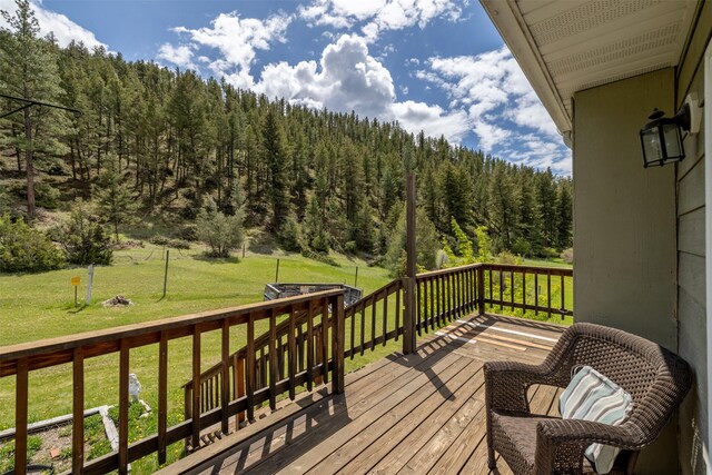 7551 York Rd, Helena, MT 59602 - deck featuring a forest view and a yard