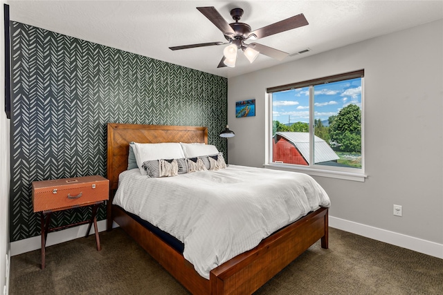 380 Stonybrook Dr, Missoula, MT 59804 - carpeted bedroom featuring an accent wall, wallpapered walls, baseboards, and a ceiling fan