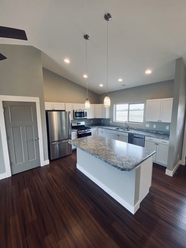 3883 Lovegrass Ln, Helena, MT 59602 - kitchen featuring stainless steel appliances, a sink, a center island, white cabinets, and vaulted ceiling