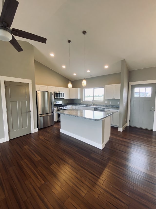 3883 Lovegrass Ln, Helena, MT 59602 - kitchen featuring appliances with stainless steel finishes, a center island, a sink, white cabinetry, and hanging light fixtures