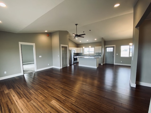 3883 Lovegrass Ln, Helena, MT 59602 - unfurnished living room with ceiling fan, lofted ceiling, dark wood-style floors, baseboards, and recessed lighting