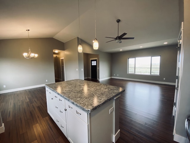 3883 Lovegrass Ln, Helena, MT 59602 - kitchen with a kitchen island, vaulted ceiling, open floor plan, ceiling fan, and baseboards
