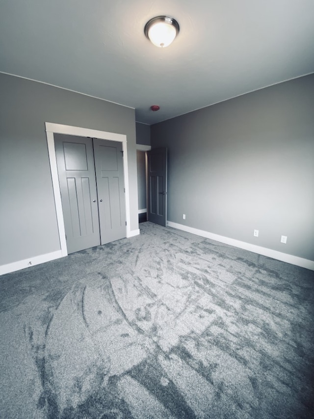 3883 Lovegrass Ln, Helena, MT 59602 - unfurnished bedroom with baseboards, carpet floors, and a closet