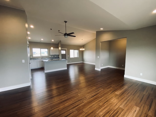 3883 Lovegrass Ln, Helena, MT 59602 - unfurnished living room with a ceiling fan, dark wood finished floors, a chandelier, baseboards, and lofted ceiling