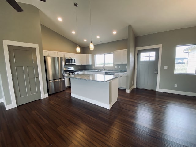 3883 Lovegrass Ln, Helena, MT 59602 - kitchen with appliances with stainless steel finishes, a center island, a sink, white cabinetry, and hanging light fixtures
