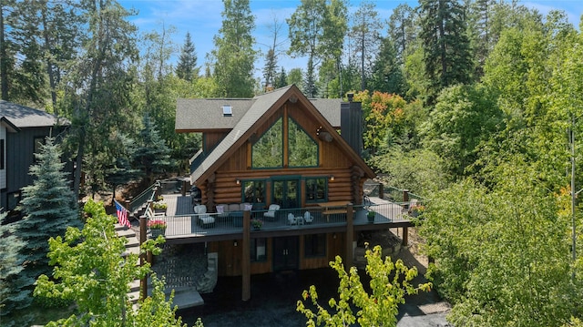 970 Colorado Ave, Whitefish, MT 59937 - rear view of property featuring log siding, a chimney, and a wooden deck