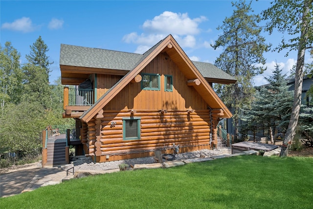 970 Colorado Ave, Whitefish, MT 59937 - view of property exterior with stairway, log exterior, a yard, and a balcony