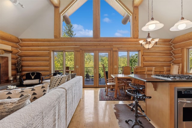 970 Colorado Ave, Whitefish, MT 59937 - living room featuring rustic walls, high vaulted ceiling, hardwood / wood-style flooring, french doors, and healthy amount of natural light