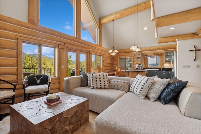 970 Colorado Ave, Whitefish, MT 59937 - living area with log walls, high vaulted ceiling, beam ceiling, french doors, and recessed lighting