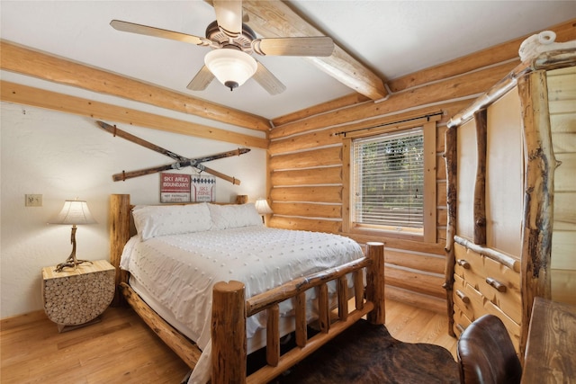 970 Colorado Ave, Whitefish, MT 59937 - bedroom with rustic walls, hardwood / wood-style floors, beamed ceiling, and a ceiling fan