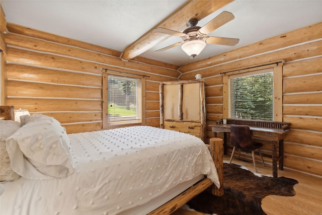 970 Colorado Ave, Whitefish, MT 59937 - bedroom featuring multiple windows, beam ceiling, wood finished floors, and a ceiling fan