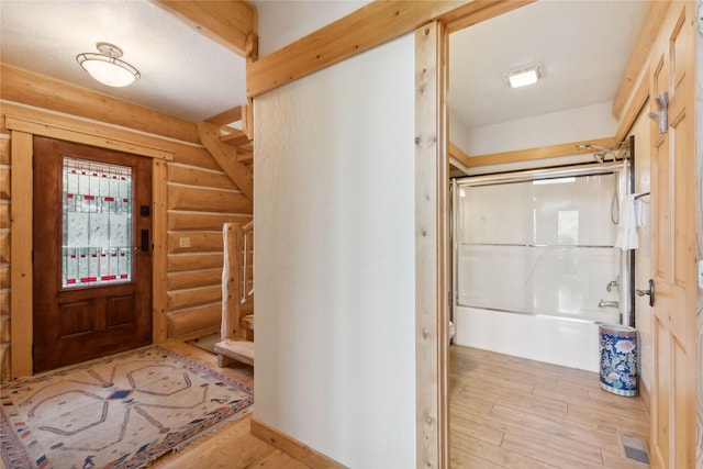 970 Colorado Ave, Whitefish, MT 59937 - entryway featuring log walls, light wood-style floors, and stairs