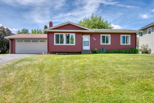 229 Glacier Dr, Lolo, MT 59847 - ranch-style house with entry steps, a chimney, a garage, driveway, and a front yard