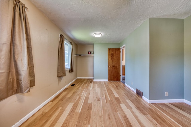 229 Glacier Dr, Lolo, MT 59847 - empty room featuring wood finished floors, baseboards, and a textured ceiling