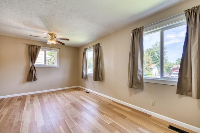 229 Glacier Dr, Lolo, MT 59847 - empty room with light wood-type flooring, baseboards, ceiling fan, and a textured ceiling