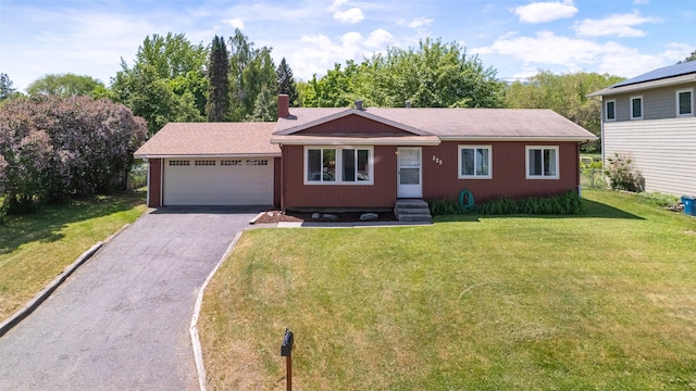 229 Glacier Dr, Lolo, MT 59847 - ranch-style house with an attached garage, driveway, a front lawn, and a chimney