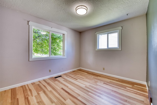 229 Glacier Dr, Lolo, MT 59847 - spare room featuring wood finished floors, baseboards, and a textured ceiling