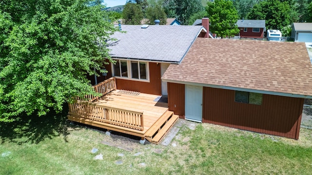 229 Glacier Dr, Lolo, MT 59847 - back of house featuring roof with shingles, a deck, and a yard