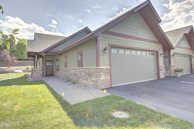 178 Meadow Vista Loop Unit A, Kalispell, MT 59901 - craftsman-style home with stone siding, asphalt driveway, a garage, a front lawn, and roof with shingles