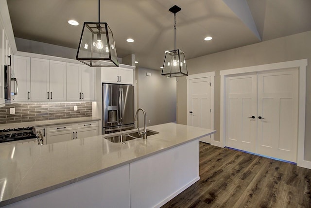 178 Meadow Vista Loop Unit A, Kalispell, MT 59901 - kitchen with stainless steel appliances, a sink, backsplash, white cabinetry, and dark wood-style floors