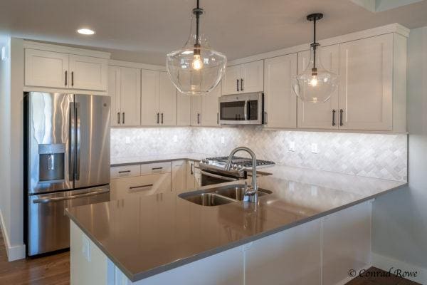 178 Meadow Vista Loop Unit A, Kalispell, MT 59901 - kitchen featuring stainless steel appliances, white cabinets, a peninsula, decorative light fixtures, and recessed lighting