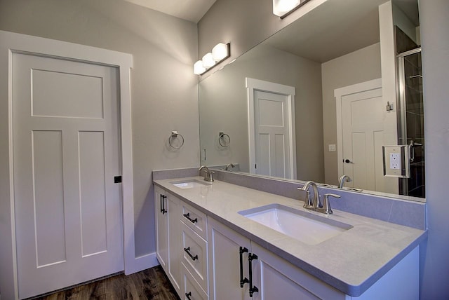 178 Meadow Vista Loop Unit A, Kalispell, MT 59901 - bathroom with double vanity, wood finished floors, baseboards, and tiled shower