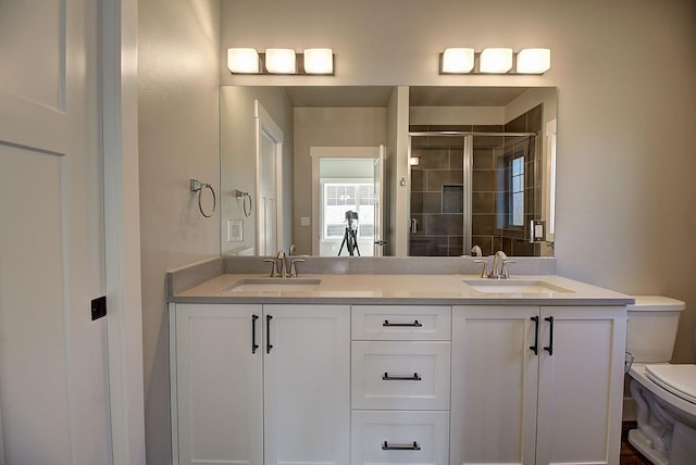 178 Meadow Vista Loop Unit A, Kalispell, MT 59901 - bathroom featuring toilet, double vanity, and a stall shower