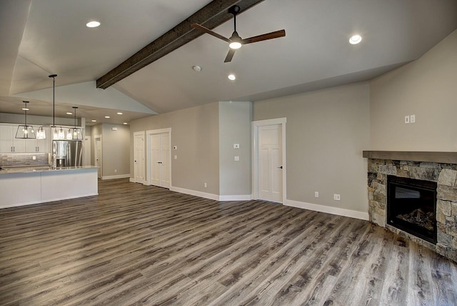178 Meadow Vista Loop Unit A, Kalispell, MT 59901 - unfurnished living room featuring a ceiling fan, dark wood-style floors, a fireplace, recessed lighting, and baseboards
