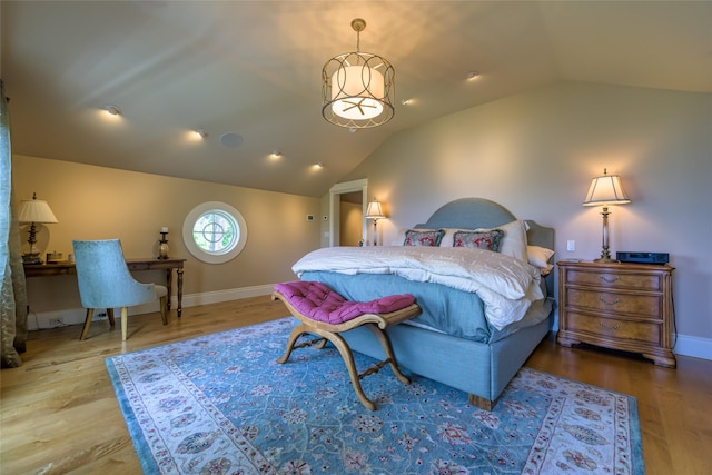 33702 N Finley Point Rd, Polson, MT 59860 - bedroom with lofted ceiling, wood finished floors, and baseboards