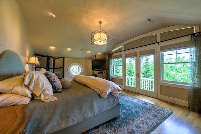 33702 N Finley Point Rd, Polson, MT 59860 - bedroom featuring lofted ceiling, access to exterior, and wood finished floors