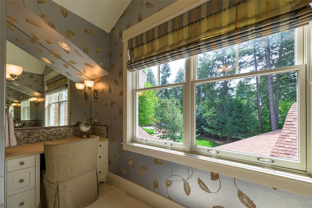 33702 N Finley Point Rd, Polson, MT 59860 - bathroom with wallpapered walls, vanity, baseboards, tile patterned flooring, and lofted ceiling