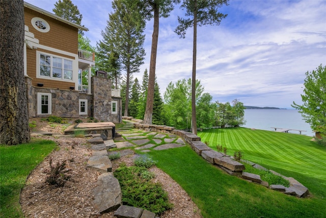 33702 N Finley Point Rd, Polson, MT 59860 - view of green lawn with a balcony and a water view
