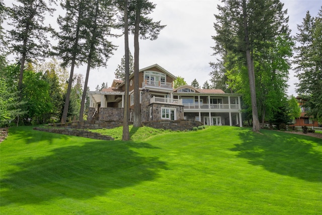33702 N Finley Point Rd, Polson, MT 59860 - rear view of property with stone siding, a yard, and a balcony
