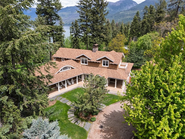 33702 N Finley Point Rd, Polson, MT 59860 - aerial view of property and surrounding area featuring a mountain backdrop and a forest