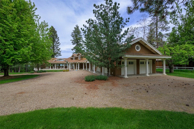 33702 N Finley Point Rd, Polson, MT 59860 - view of front of house featuring driveway, a porch, and a garage