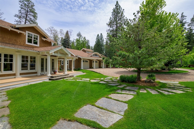 33702 N Finley Point Rd, Polson, MT 59860 - view of grassy yard featuring driveway and covered porch