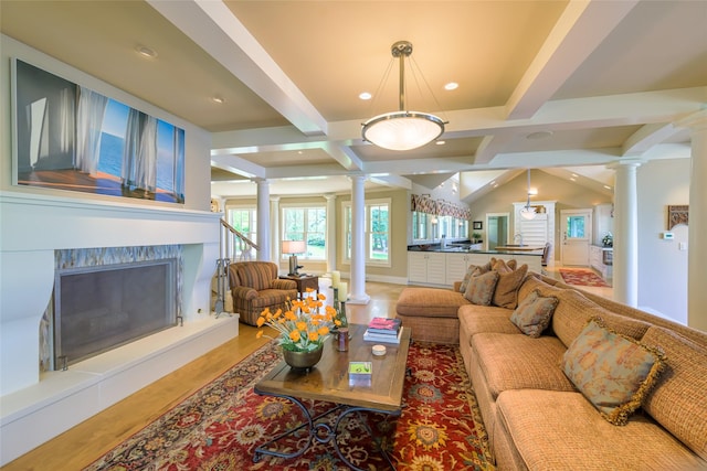 33702 N Finley Point Rd, Polson, MT 59860 - living room featuring ornate columns, beamed ceiling, a fireplace, wood finished floors, and recessed lighting
